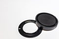 Sony lens adapter and cap on a white background. Copy space