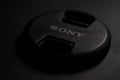 Sony lens cap isolated with black surface Royalty Free Stock Photo