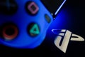 Sony Playstation logo illuminated on blue light from game controller Royalty Free Stock Photo