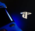 Sony Playstation logo illuminated on blue light from game controller