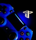 Sony Playstation logo illuminated on blue light from game controller