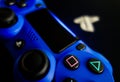 Sony Playstation logo illuminated on blue light from game controller Royalty Free Stock Photo