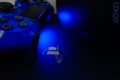 Sony Playstation logo illuminated on blue light from game controller