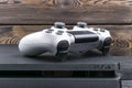 Sony PlayStation 4 Slim 1Tb revision and dualshock game controller. Game console with a joystick. Home video game console