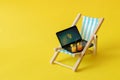 Sony`s miniature laptop on a miniature blue deck chair. Freelance Part time Outsources Job Employment Concept. Work on travel. Royalty Free Stock Photo