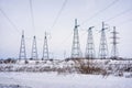 Supports overhead power lines in winter. Royalty Free Stock Photo