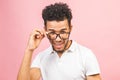 Soon to be startup owner or salesman. Portrait of cool and handsome african male student looking at camera smiling with eyeglasses Royalty Free Stock Photo