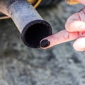 Soot from the exhaust pipe on the finger. Examination of the car Royalty Free Stock Photo