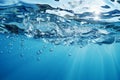 Soothing blue water background with bubbles and glistening water surface Royalty Free Stock Photo