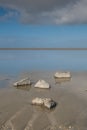 A soothing picture of the wadden sea at paesens moddergat, big rock in foreground, sea and sky