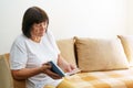 Soothing reading. Portrait of thoughtful elderly woman reading her favorite Royalty Free Stock Photo