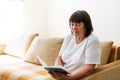 Soothing reading. Portrait of thoughtful elderly woman reading her favorite Royalty Free Stock Photo