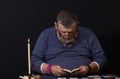 Soothsayer reading small book before doing cartomancy