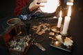 Soothsayer using crystal ball to predict future at table in darkness closeup Royalty Free Stock Photo