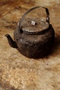 Sooty old teapot on old table in open kitchen Royalty Free Stock Photo