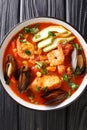 Sopa de Mariscos Seafood Soup closeup in the plate. Vertical top view Royalty Free Stock Photo