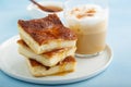 Sopapilla cheesecake bars with cinnamon drizzled with honey