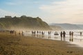 Sopelana Beach, Spain - August 16 2019: People walking on the beach. Beautiful sunset in Basque Country, north of Spain Royalty Free Stock Photo