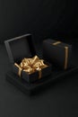 Two Black Gift Boxes Mockup with Golden Wrapping Paper, Opened and Closed On Black Background Royalty Free Stock Photo