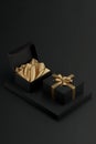 Two Black Gift Boxes Mockup with Golden Wrapping Paper, Opened and Closed On Black Background Royalty Free Stock Photo