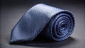 A sophisticated navy blue necktie with a subtle white polka dot pattern, elegantly rolled and ready for a formal occasion, Royalty Free Stock Photo