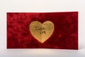 A sophisticated red Valentine\'s Day card, featuring a velvet texture and a gold foil heart in the center