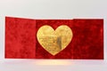 A sophisticated red Valentine\'s Day card, featuring a velvet texture and a gold foil heart in the center