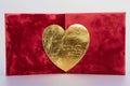 A sophisticated red Valentine\'s Day card, featuring a velvet texture and a gold foil heart in the center