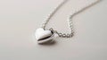 A sophisticated silver heart pendant on a delicate chain, capturing the essence of timeless affection and cherished moments