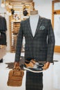 Sophisticated suit with derby shoes and a bag on the mannequin on the display Royalty Free Stock Photo