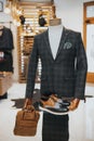 Sophisticated suit with derby shoes and a bag on the mannequin on the display Royalty Free Stock Photo