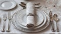 Elegant table setting with silverware, plates, and a decorative napkin ring Royalty Free Stock Photo