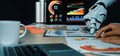 Futuristic Workspace with Robot Hand Analyzing Data and Business Charts on Table, Highlighting Technology and Modern Royalty Free Stock Photo