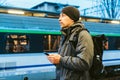 Sopot Fast Urban Railway station. young man standing and waiting train on platform. tourist travels by train. Portrait Of Royalty Free Stock Photo