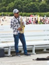 Sopot / Poland - August 3 2019: A saxophonist busker blowing the sax for money on the pier Royalty Free Stock Photo