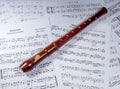Soprano block flute lies on a music sheet.