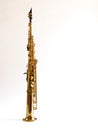 Soprano Sax, wind instrument saxophone staying on a white background, vertical, copy space Royalty Free Stock Photo