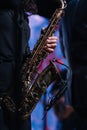 Soprano saxophone in hands on a dark background. Alto sax musical instrument closeup Royalty Free Stock Photo
