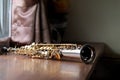 Soprano Saxophone on the Wood Table in the Morning, Selective Focus Silver Plated Golden Key Saxophone Picture