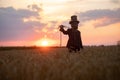 Sorcerer performs black magic ritual and portrays hanged man at sunset