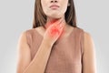 Sore throat woman on gray background Royalty Free Stock Photo