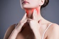 Sore throat, woman with pain in neck, gray background Royalty Free Stock Photo