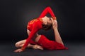 Sorgeous sporty woman in red clothing doing yoga exercise Royalty Free Stock Photo