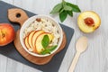 Sorghum salad with nuts and fresh peach on stone board