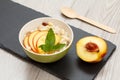 Sorghum salad with nuts and fresh peach on gray boards Royalty Free Stock Photo