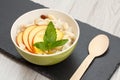 Sorghum salad with nuts and fresh peach on gray wooden boards