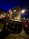 Soria, Spain - April 11, 2022: Holy Week procession of hooded people down the street carrying the Christ