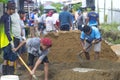 Villagers work together to repair damaged village footpaths.