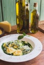 Sorrentino with parmesan cheese and olive oil on a wooden table