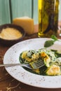 Sorrentino with parmesan cheese and olive oil on a wooden table